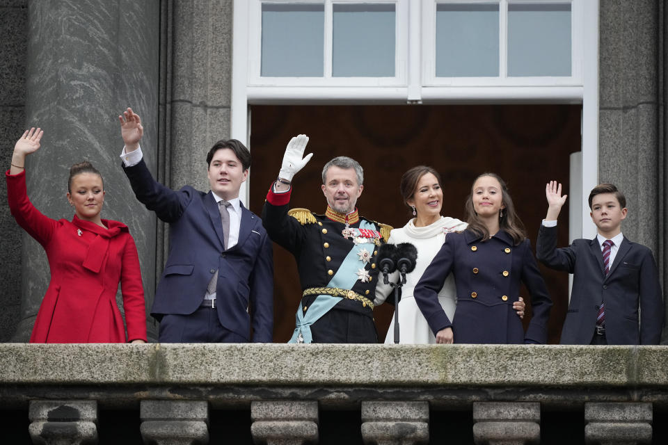 Denmark's King Frederik X and Queen Mary, together with their children from left, Princess Josephine, Crown Prince Christian, Princess Isabella and Prince Vincent wave after the proclamation, at Christiansborg Palace, in Copenhagen, Sunday, Jan. 14, 2024. Denmark's prime minister proclaimed Frederik X as king after his mother Queen Margrethe II formally signed her abdication. Massive crowds turned out to rejoice in the throne passing from a beloved monarch to her popular son. (AP Photo/Martin Meissner)