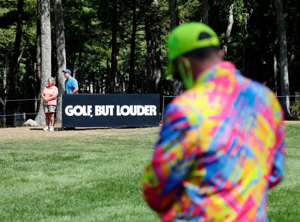 A fan wears a color jacket as he waits for players on the practice putting green before the second round of the LIV Golf Invitational-Boston tournament Sept. 3 in Bolton.