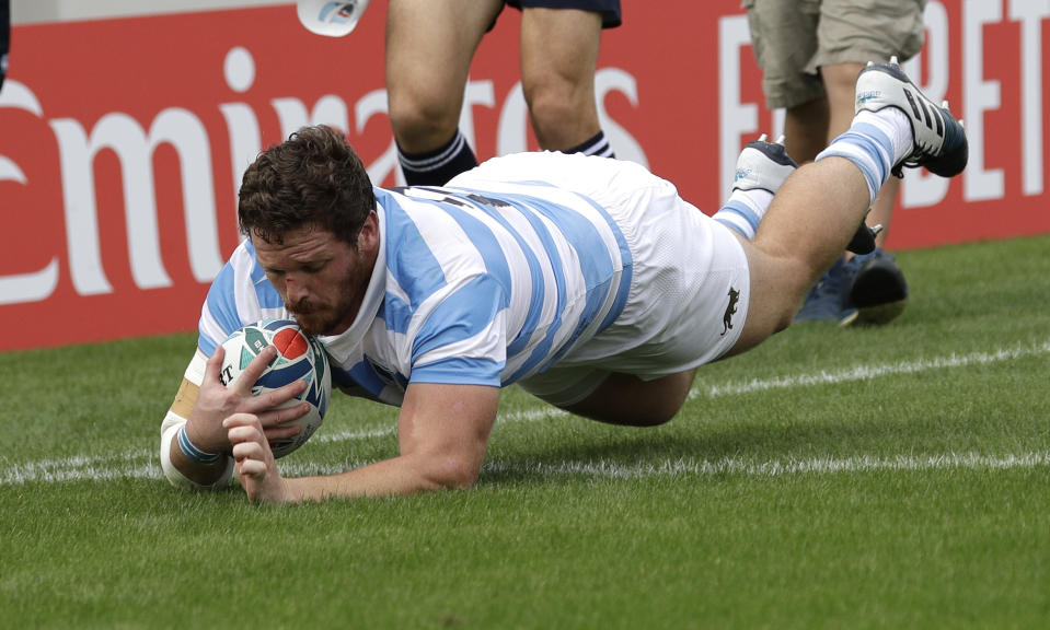 Argentina's Julián Montoya dives across the line to score his team's first try during the Rugby World Cup Pool C game at Hanazono Rugby Stadium between Tonga and Argentina in Osaka, Japan, Saturday, Sept. 28, 2019. (AP Photo/Aaron Favila)