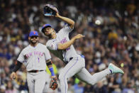 New York Mets' Francisco Lindor, right, is unable to throw Milwaukee Brewers' Eduardo Escobar out at first base during the sixth inning of a baseball game Saturday, Sept. 25, 2021, in Milwaukee. (AP Photo/Aaron Gash)