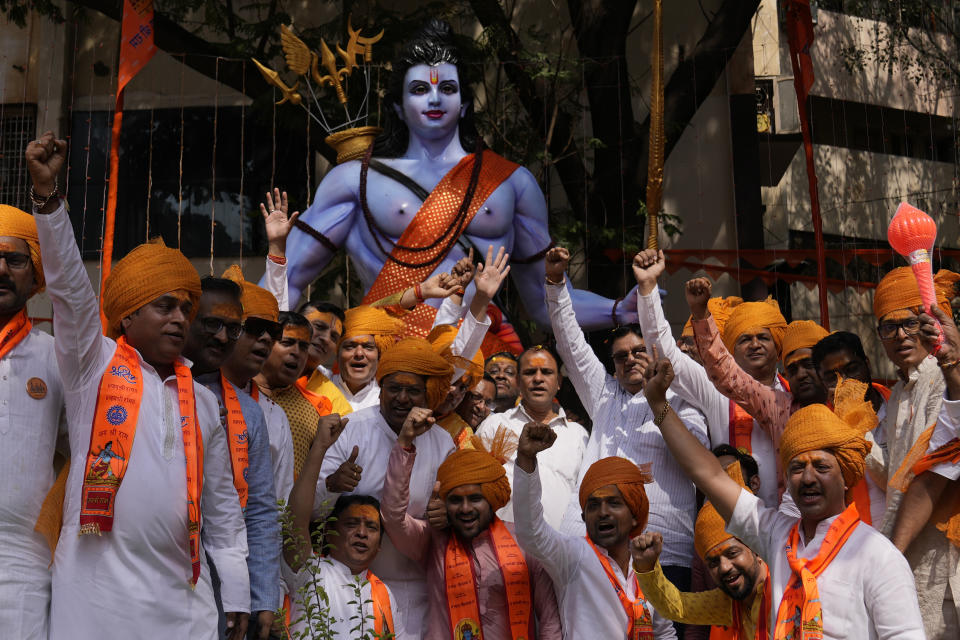 Hindu devotees pose next to an image of Hindu Lord Ram at a religious procession in Hyderabad, India, during the inauguration of a temple dedicated to Ram in Ayodhya, Monday, Jan. 22, 2024. Indian Prime Minister Narendra Modi on Monday opened a controversial Hindu temple built on the ruins of a historic mosque in the holy city of Ayodhya in a grand event that is expected to galvanize Hindu voters in upcoming elections. (AP Photo/Mahesh Kumar A.)