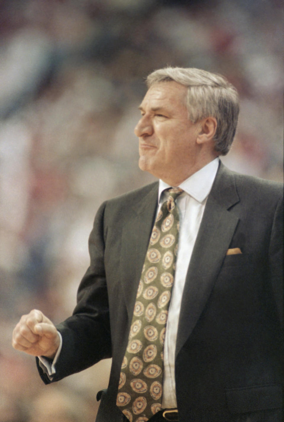 North Carolina coach Dean Smith calls out a play from the sidelines during his team’s NCAA Tournament first-round game against Miami, Ohio. North Carolina won, 68-63, to give Smith his record 48th NCAA Tournament win in Cincinnati, March 20, 1992. AP Photo/Al Behrman