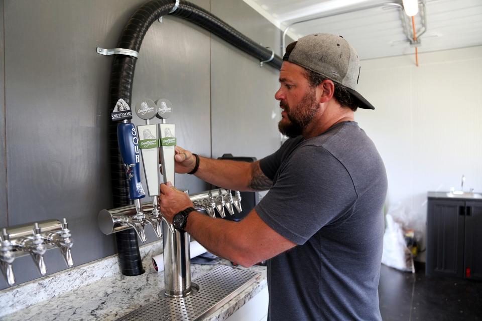 General manager Travis Glazier assembles beer taps at the Smuttynose Beer Garden at The Ridge in Rochester, which opened last weekend and will be open seven days a week, noon to 9 p.m., throughout the summer.