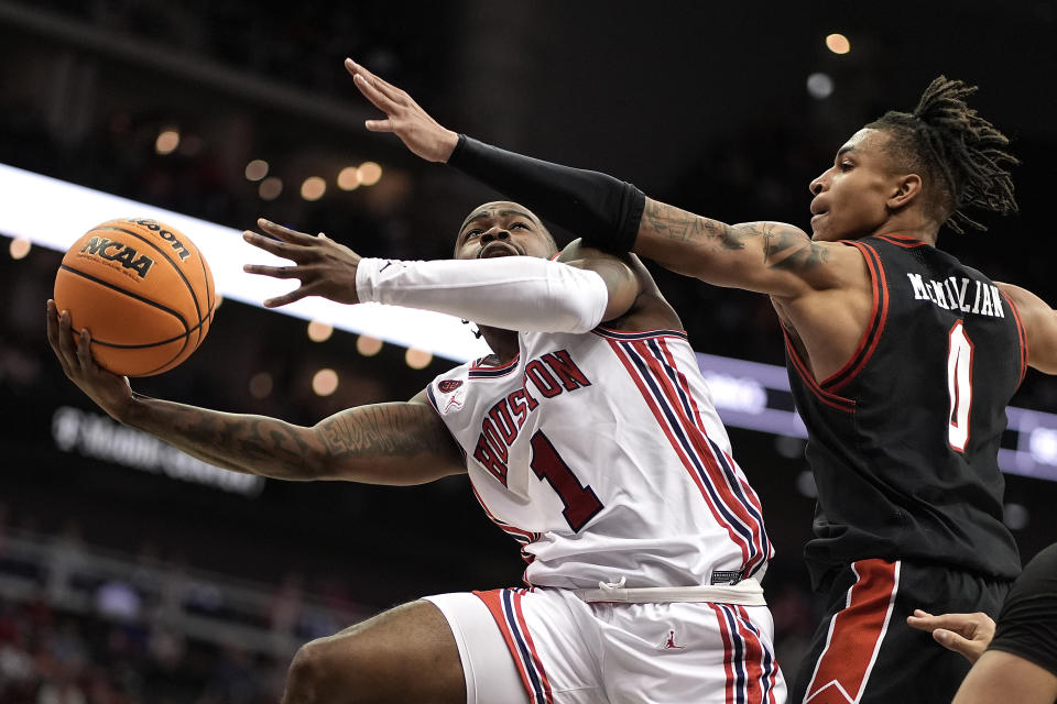 Houston guard Jamal Shead (1) shoots under pressure from Texas Tech guard Chance McMillian (0) during the second half of an NCAA college basketball game in the semifinal round of the Big 12 Conference tournament, Friday, March 15, 2024, in Kansas City, Mo. (AP Photo/Charlie Riedel)