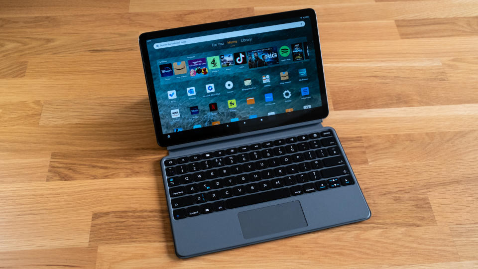 Amazon Fire Max 11 tablet with keyboard attached on a wooden surface