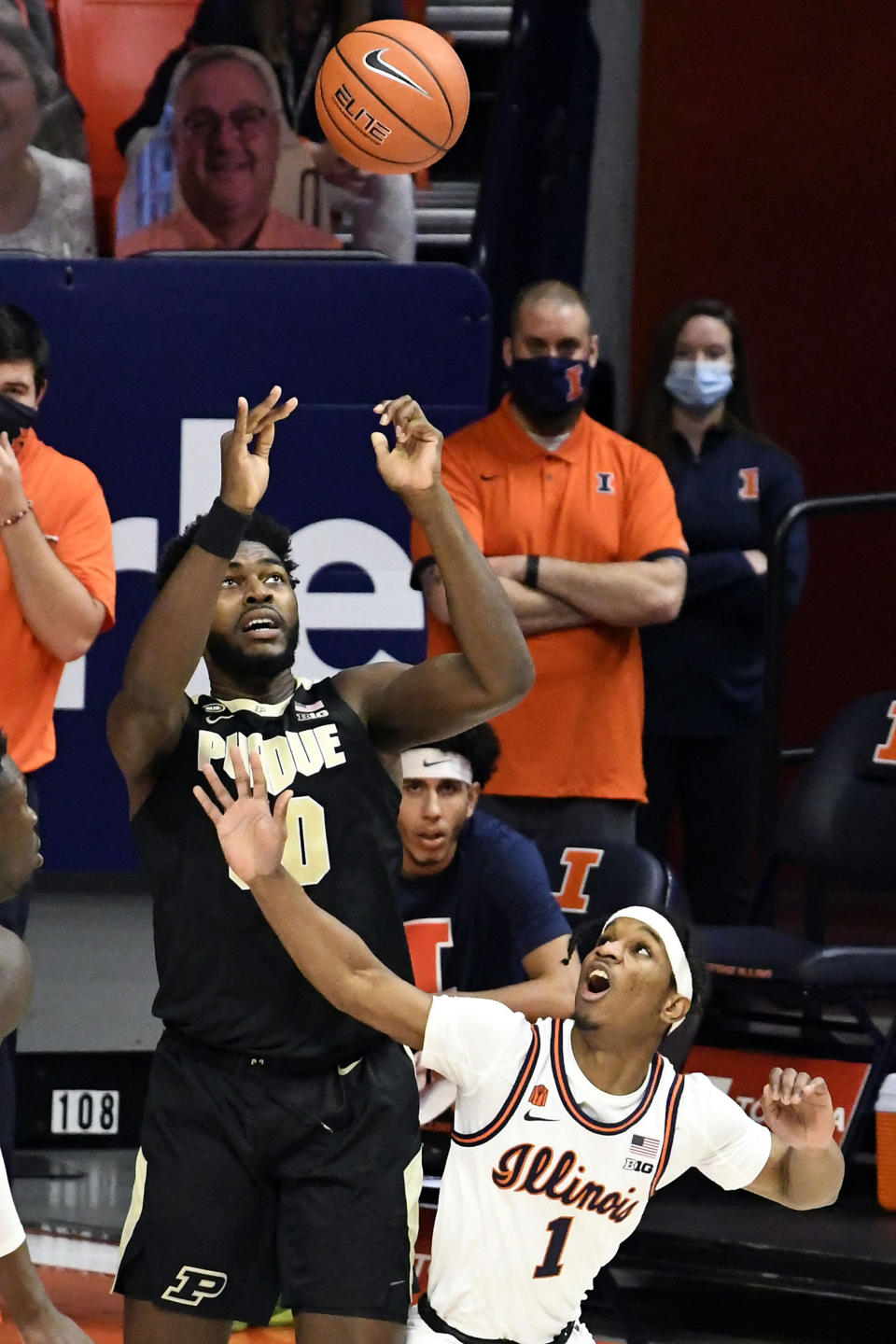 Purdue's forward Trevion Williams (50) tries to control the ball after it is tipped by Illinois guard Trent Frazier (1) in the first half of an NCAA college basketball game Saturday, Jan. 2, 2021, in Champaign, Ill. (AP Photo/Holly Hart)