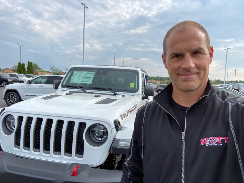 Thad Szott stopped by Feeny Chrysler Jeep Dodge Ram in Gaylord, Michigan as he checked inventory levels around the state and discovered  Jeep Wrangler had sold out. Szott, co-owner of Szott Auto Group in White Lake Charter Township, is pictured beside a hot-selling new Jeep Gladiator pickup styled after the Wrangler on July 6, 2020.