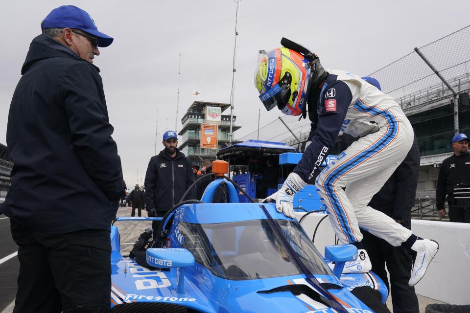 Alex Palou, of Spain, climbs into his car during IndyCar auto racing testing at Indianapolis Motor Speedway, Wednesday, April 20, 2022, in Indianapolis. (AP Photo/Darron Cummings)