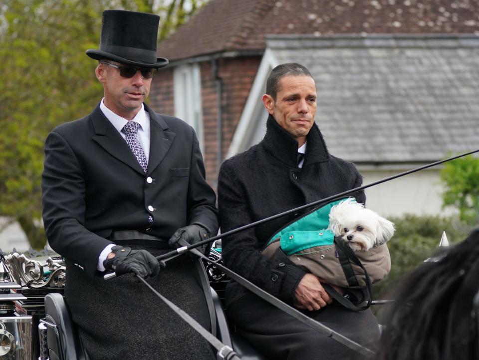 Husband of Paul O'Grady Andre Portasio (right)rides with the funeral cortege as it travels through the village of Aldington, Kent, ahead of his funeral at St Rumwold's Church. Picture date: Thursday April 20, 2023.