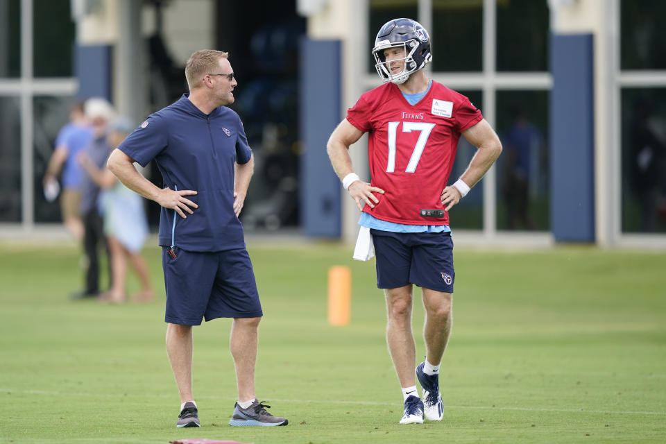 Tennessee Titans quarterback Ryan Tannehill (17) talks with offensive coordinator Todd Downing during NFL football practice Thursday, June 3, 2021, in Nashville, Tenn. (AP Photo/Mark Humphrey, Pool)