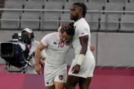 Madison Hughes, left, of the United States and teammate Matai Leuta react after the U.S. team lost to Britain in their men's rugby sevens quarterfinal match at the 2020 Summer Olympics, Tuesday, July 27, 2021, in Tokyo. (AP Photo/Shuji Kajiyama)