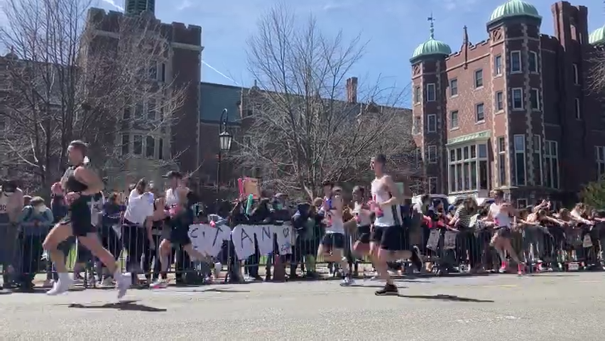 Boston Marathon runners pass by the "scream tunnel" in front of Wellesley College, April 18, 2022.