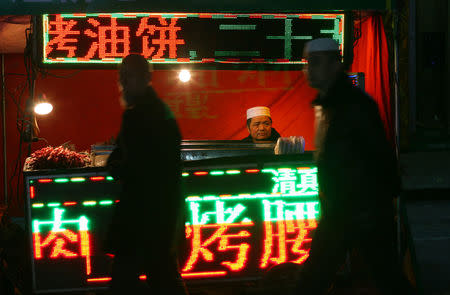 A man sells food at a night market in China's Linxia, Gansu province, home to a large population of ethnic minority Hui Muslims, February 1, 2018. Picture taken February 1, 2018. REUTERS/Michael Martina