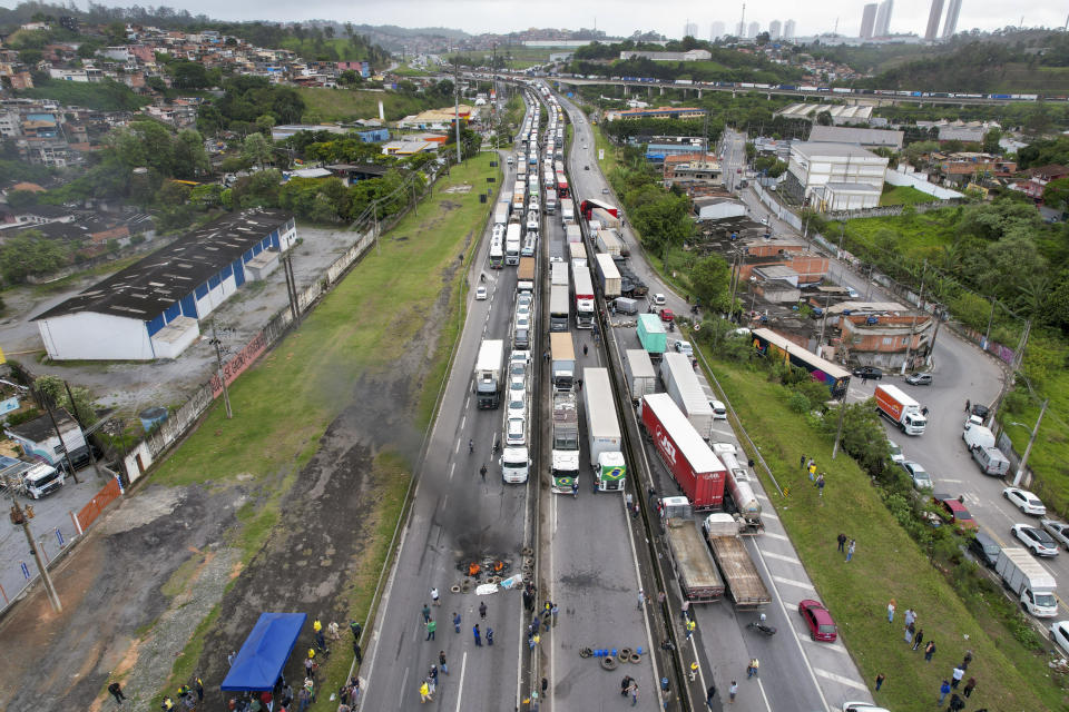 Truckers supportive of President Jair Bolsonaro block a highway to protest his run-off election loss to former President Luiz Inacio Lula da Silva in Embu das Artes, outskirts of Sao Paulo, Brazil, Tuesday, Nov. 1, 2022. (AP Photo/Andre Penner)