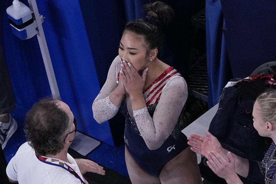 Sunisa Lee, of the United States, reacts after getting her score on the floor performs on the during the artistic gymnastics women's all-around final at the 2020 Summer Olympics, Thursday, July 29, 2021, in Tokyo. (AP Photo/Morry Gash)