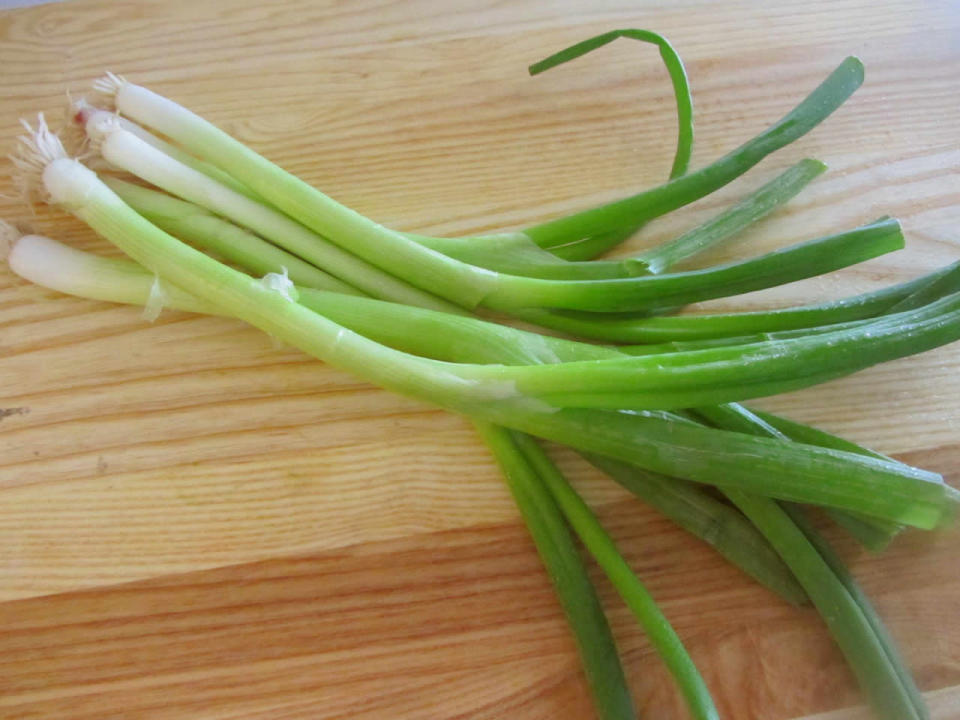 <p>Storage time: 1-3 weeks. Arguably one of the coolest veggies to store, you can save yourself 70 cents at the checkout by regrowing your green onions without the need for potting soil or any semblance of a green thumb. Place the onions in a jar or glass, root-side down, and fill with water to cover the white roots. Store the jar near the window, change the water every couple of days, and voila: you can cut, eat and regrow these beauties at least a couple of times before they start to lose their flavour. As an added benefit, you’ll have a new houseplant of sorts. If making an onion profit isn’t your priority, you can store your green onions by wrapping them in a damp paper towel and storing them in either a loose plastic bag or container in your fridge. If your onions are starting to look limp and lifeless, give them an icy bath to shock them back to their former firm build. <i>(Photo: Getty)</i></p>