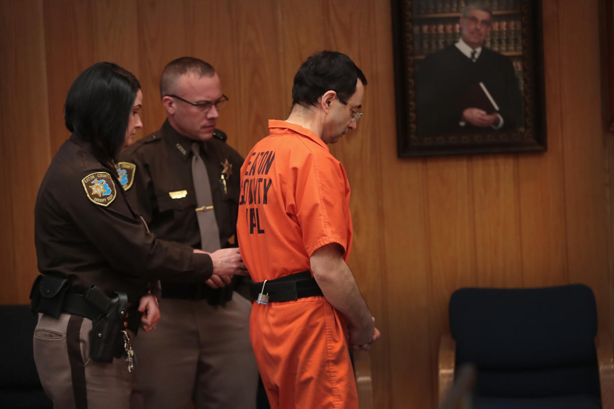 CHARLOTTE, MI - FEBRUARY 05:  Larry Nassar is led from the courtroom after being sentenced by Judge Janice Cunningham to 40 to 125 years in prison for three counts of criminal sexual assault in Eaton County Circuit Court on February 5, 2018 in Charlotte, Michigan. Nassar has been accused of sexually assaulting more than 150 girls and young women while he was a physician for USA Gymnastics and Michigan State University. He is currently serving a 60-year sentence in federal prison for possession of child pornography. Last month a judge in Ingham County, Michigan sentenced Nassar to an 40 to 175 years in prison after he plead guilty to sexually assaulting seven girls.  (Photo by Scott Olson/Getty Images)