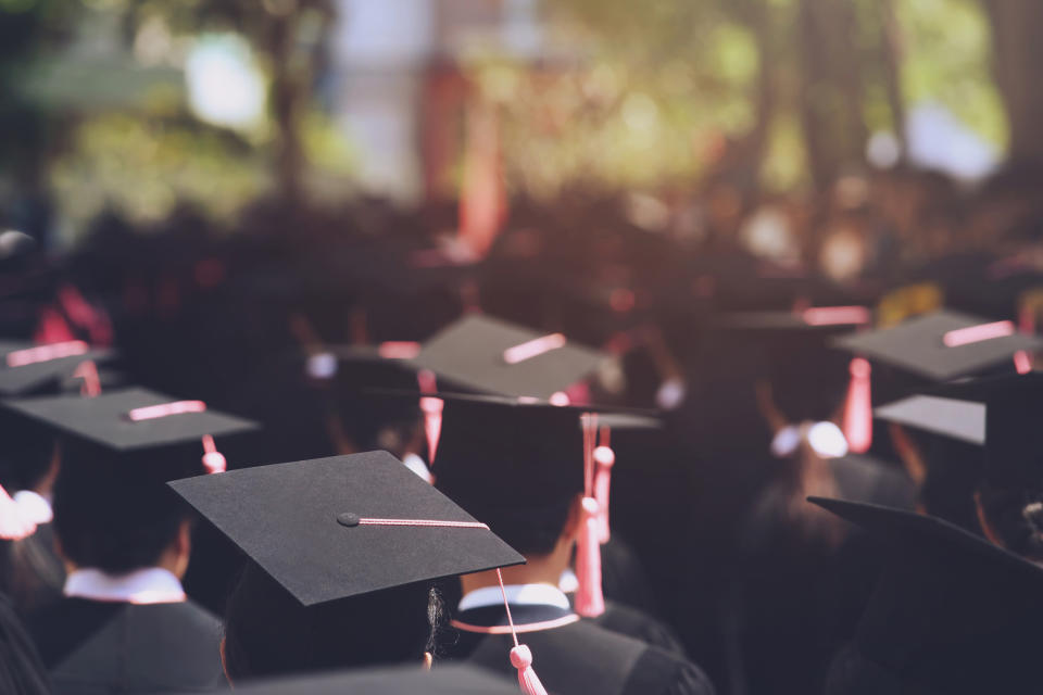 Graduates in caps and gowns at a commencement ceremony