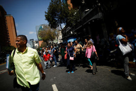 People wait for transportation outside a closed metro station during a blackout in Caracas, Venezuela March 25, 2019. REUTERS/Carlos Garcia Rawlins