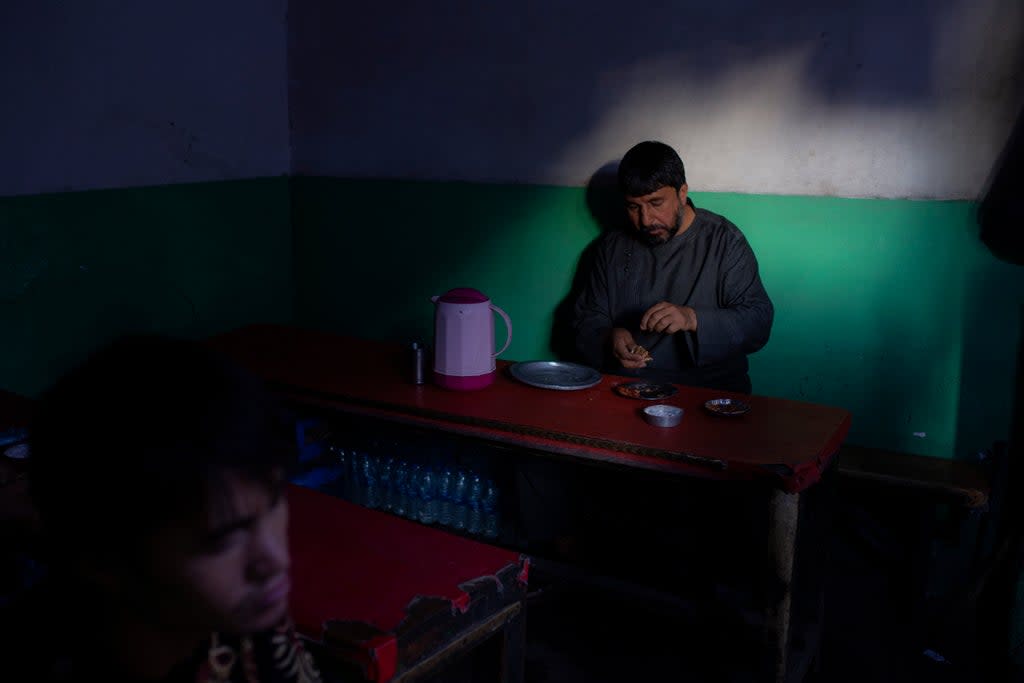 An Afghan man eats lunch at a market restaurant in Kabul  (AP)