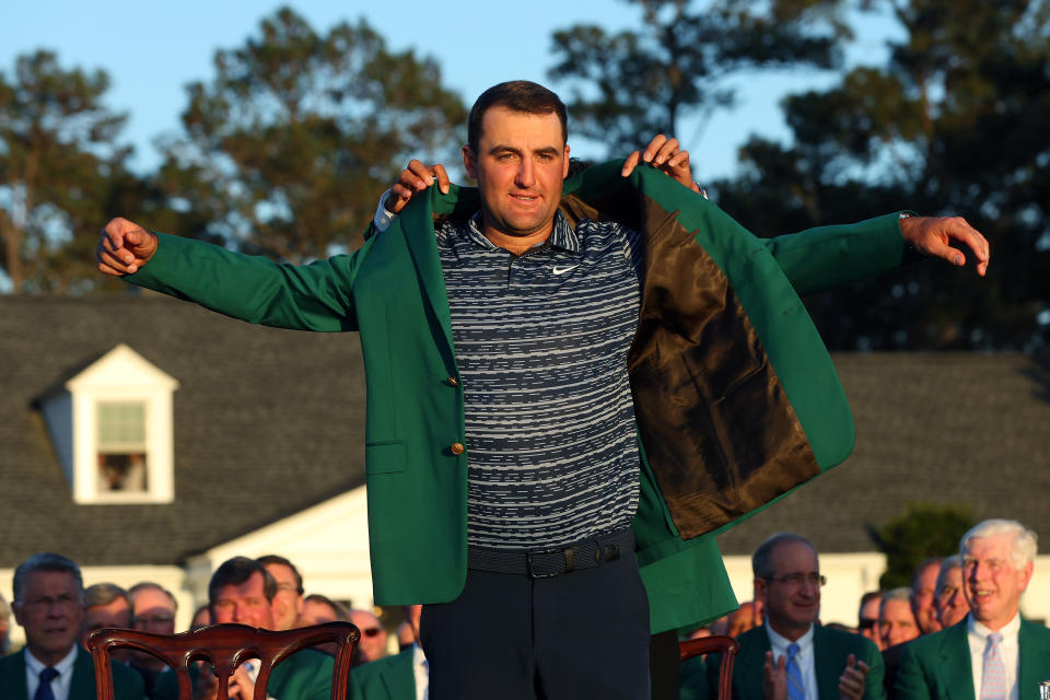 AUGUSTA, GEORGIA - APRIL 10: Scottie Scheffler is awarded the Green Jacket by 2021 Masters champion Hideki Matsuyama of Japan during the Green Jacket Ceremony after he won the Masters at Augusta National Golf Club on April 10, 2022 in Augusta, Georgia. (Photo by Andrew Redington/Getty Images)