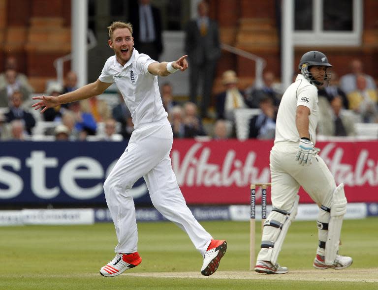 England's Stuart Broad celebrates taking the wicket of New Zealand's Ross Taylor (R) LBW for 8 runs on the fifth day of the first cricket Test match between England and New Zealand at Lord's cricket ground on May 25, 2015