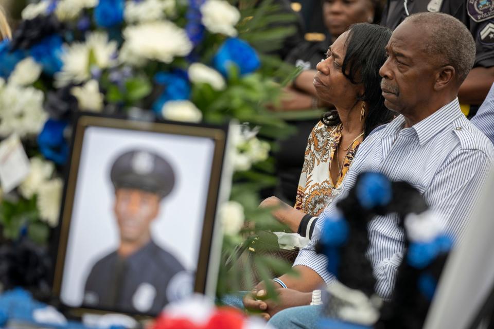 Larry and Lillian Courts, the parents of fallen officer Loren Courts, listens as members of the community and fellow officers come out to honor fallen officer Loren Courts during a vigil at the Detroit Police Department's Second Precinct on July 15, 2022. Over 200 people showed up to the Second Precinct Detroit Police Department's vigil this afternoon in honor of her late father, Loren Courts, 40, who was killed in the line of duty last week. 