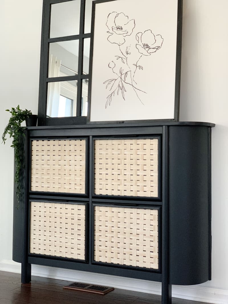 Hallway cabinet with black sides and woven wicker doors, made from IKEA HEMNES shoe cabinet.