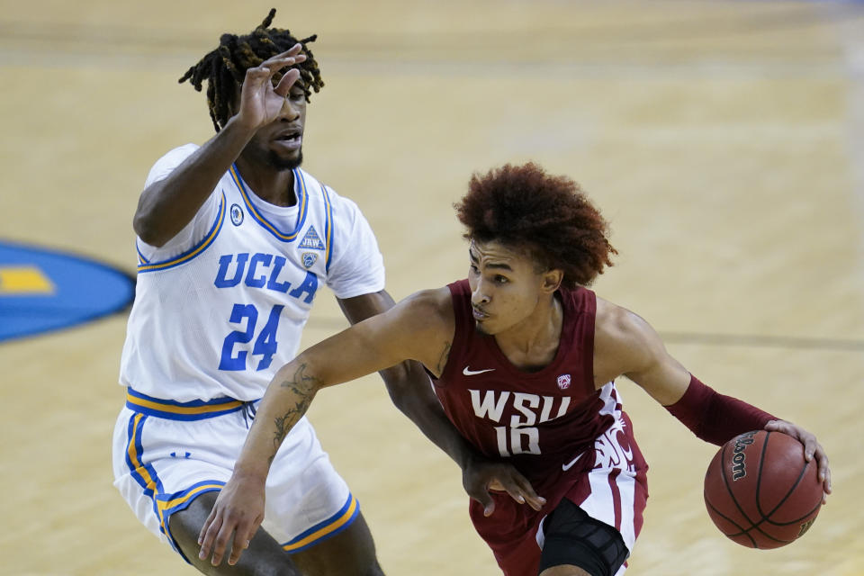 UCLA forward Jalen Hill (24) defends against Washington State guard Isaac Bonton (10) during the first quarter of an NCAA college basketball game Thursday, Jan. 14, 2021, in Los Angeles. (AP Photo/Ashley Landis)