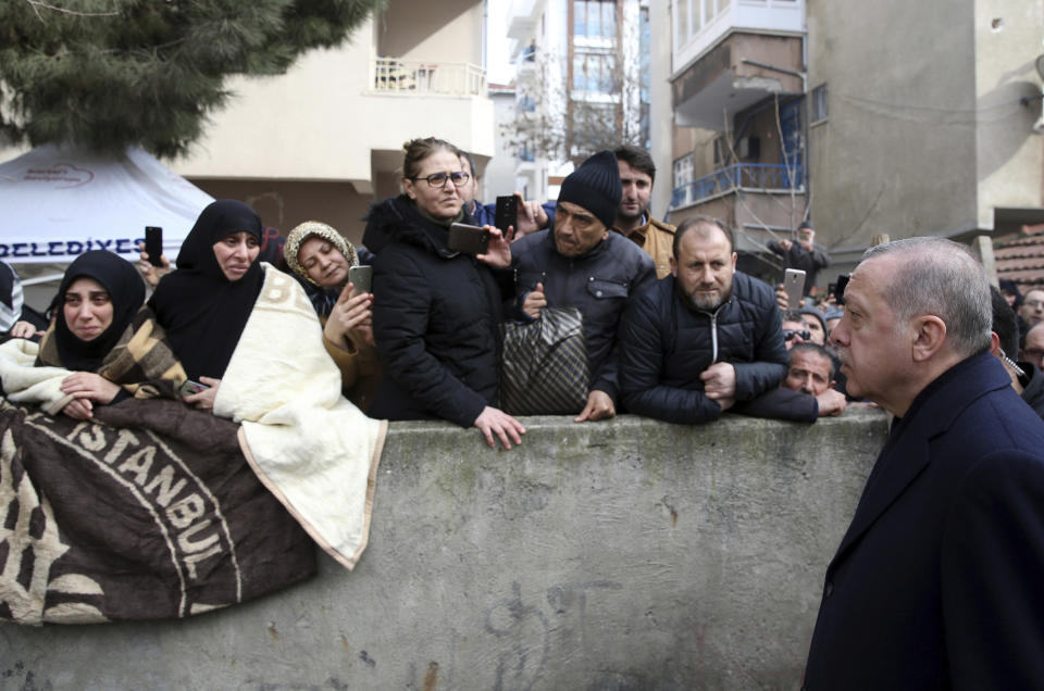 Turkey's President Recep Tayyip Erdogan speaks to people as he visits the site of a collapsed building in Istanbul, Saturday, Feb. 9, 2019. Erdogan says there are "many lessons to learn" from the collapse of a residential building in Istanbul where at least 17 people have died. (Presidential Press Service via AP, Pool)