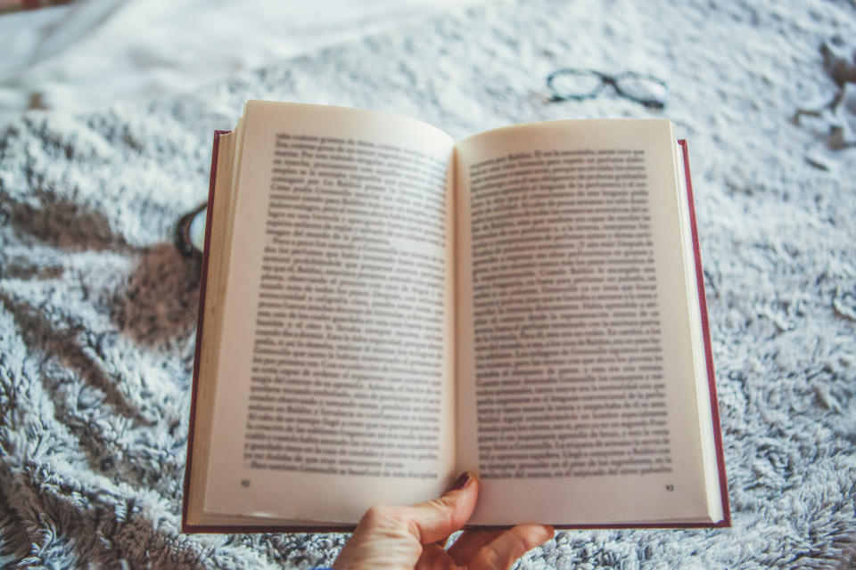 A person holding an opened book