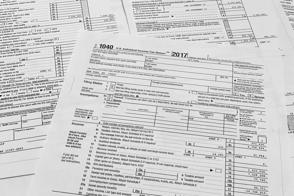 Copies of former President Donald Trump and former first lady Melania Trump individual tax returns for 2017, released by the Democratic-controlled House Ways and Means Committee, are photographed Friday, Dec. 30, 2022. The returns, which include redactions of some personal sensitive information such as Social Security and bank account numbers, span nearly 6,000 pages, including more than 2,700 pages of individual returns, and more than 3,000 pages in returns for Trump's business entities. (AP Photo/Jon Elswick)