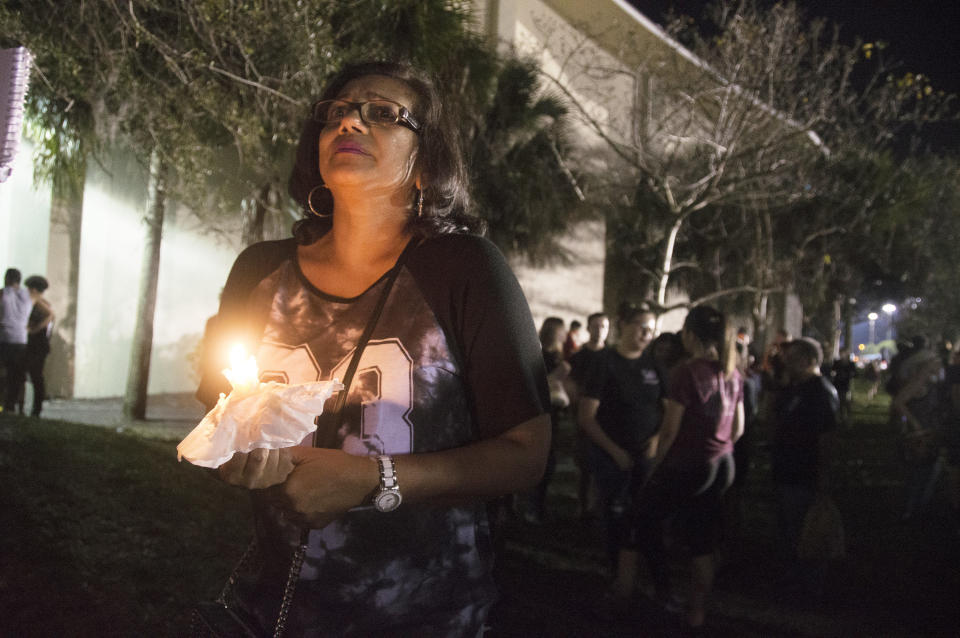 Donna Ali holds a candle at a vigil for those who lost their lives in Wednesday's school shooting in Parkland, Florida.&nbsp;