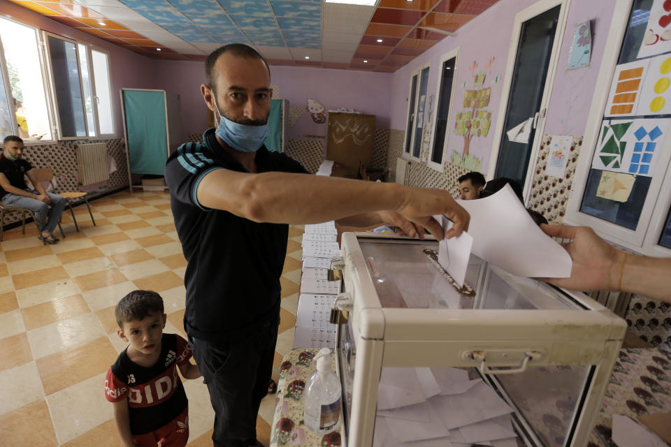 A man casts his vote in a polling station in the country's first legislative elections sine the ouster of ex-president Bouteflika, in Algiers, Algeria, Saturday, June 12, 2021. Algerians vote Saturday for a new parliament in an election with a majority of novice independent candidates running under new rules meant to satisfy demands of pro-democracy protesters and open the way to a "new Algeria." (AP Photo/Toufik Doudou)