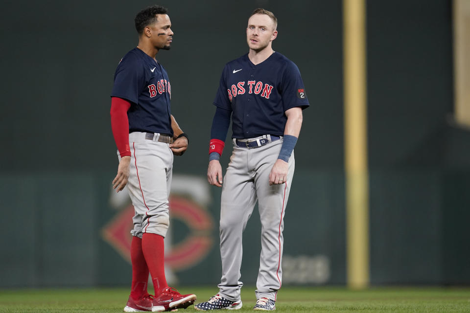 Boston Red Sox's Xander Bogaerts, left, and Boston Red Sox's Trevor Story, right, react after the top of the fifth inning of a baseball game against the Minnesota Twins, Monday, Aug. 29, 2022, in Minneapolis. (AP Photo/Abbie Parr)