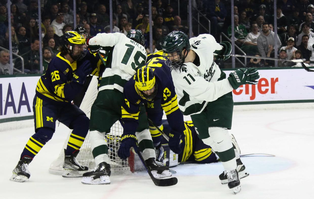 A pileup of Spartans and Wolverines at the net, Saturday, March 23, 2024, during the Big 10 Hockey final at Munn Ice Arena in East Lansing. MSU won 5-4 in overtime.