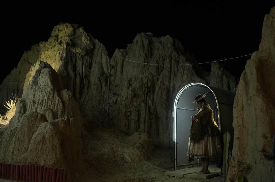 A contestant waits to be introduced while standing in the wings, during the Miss Cholita Pacena 2023 beauty pageant, in Valle de La Luna, on the outskirts of La Paz, Bolivia, June 23, 2023. (AP Photo/Juan Karita)