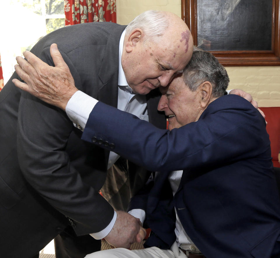 FILE - Former President of the Soviet Union Mikhail Gorbachev, left, is greeted by former U.S. President George H.W. Bush during their meeting in Houston, Thursday, Nov. 1, 2012. (AP Photo/David J. Phillip, File)
