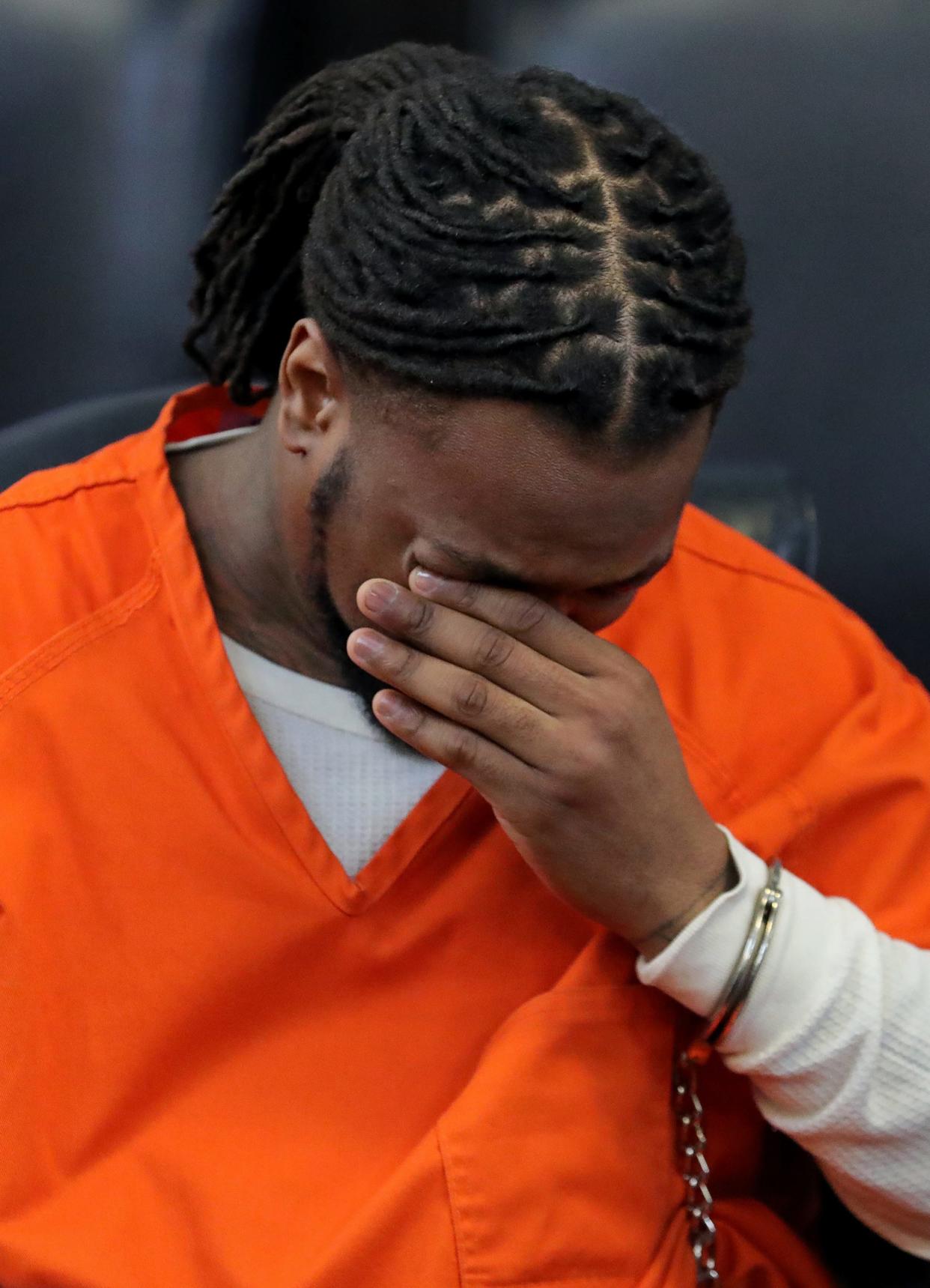 Dacarrei Kinard wipes away tears as he listens to his mother Tamara Kinard address the court before his sentencing for the road rage shooting death of George “Geo” Jensen on Friday at the Summit County Courthouse in Akron.