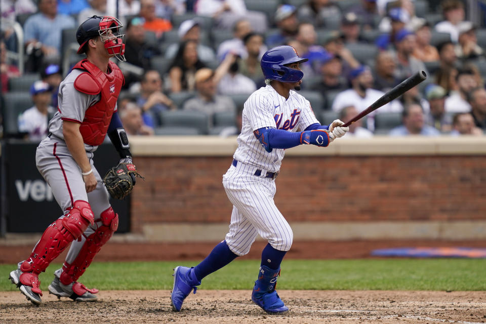 New York Mets' Francisco Lindor hits an RBI sacrifice fly off Washington Nationals relief pitcher Kyle Finnegan in the seventh inning of a baseball game, Wednesday, June 1, 2022, in New York. (AP Photo/John Minchillo)