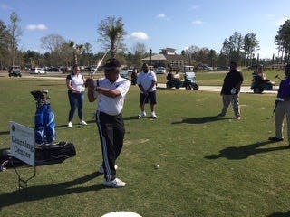 Members of 100 Black Men instruct students on how the proper golf swing. PHOTO COURTESY OF JERRY JACKSON