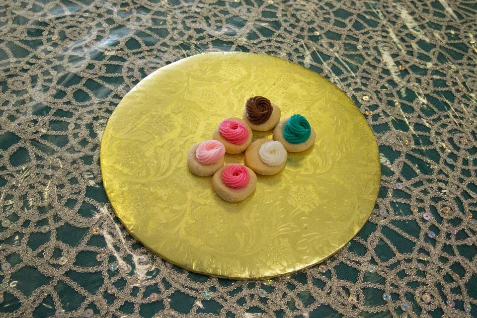 Thumbprint cookies are displayed on table at Yolanda's Speciality Cakes Friday, Aug. 25, 2023. The small cookies are sugar with colored icing.