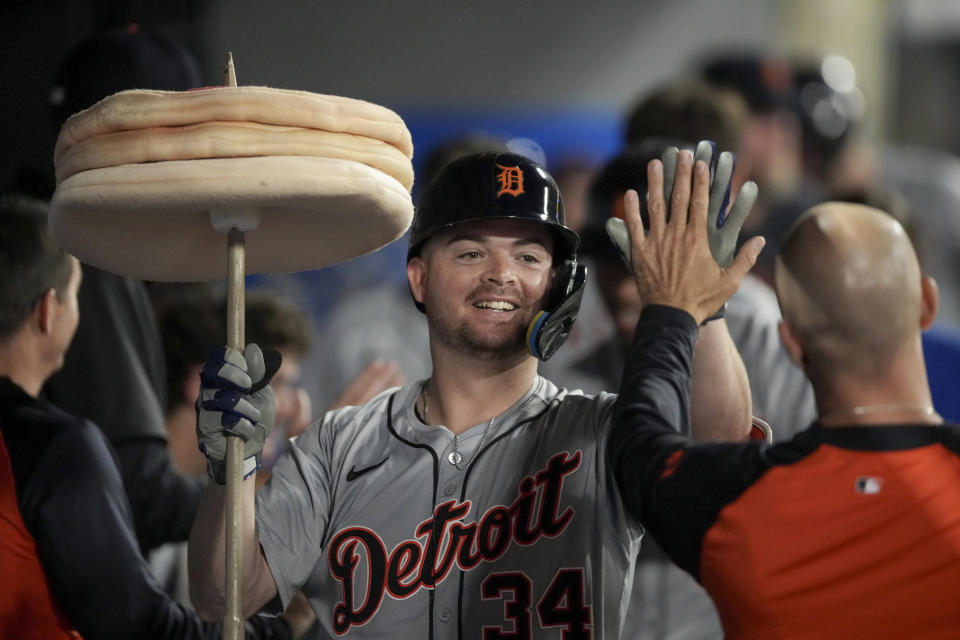 Detroit Tigers' Jake Rogers (34) high-fives a teammate in the dugout after hitting a home run against the Los Angeles Angels during the sixth inning of a baseball game in Anaheim, Calif., Saturday, June 29, 2024. (AP Photo/Eric Thayer)