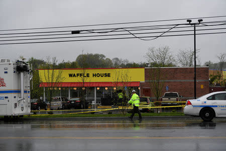FILE PHOTO: Metro Davidson County Police inspect the scene of a fatal shooting at a Waffle House restaurant near Nashville, Tennessee, U.S., April 22, 2018. REUTERS/Harrison McClary/File Photo
