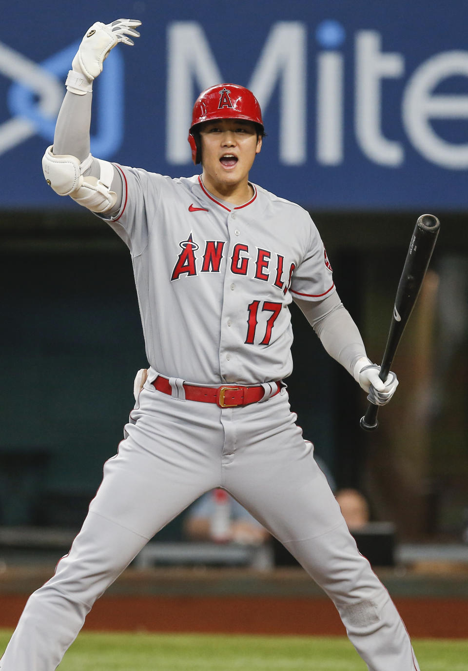 Los Angeles Angels designated hitter Shohei Ohtani (17) signals to Jack Mayfield to score a run from third on a wild pitch during the third inning of a baseball game against the Texas Rangers, Thursday, Aug. 5, 2021, in Arlington, Texas. (AP Photo/Brandon Wade)