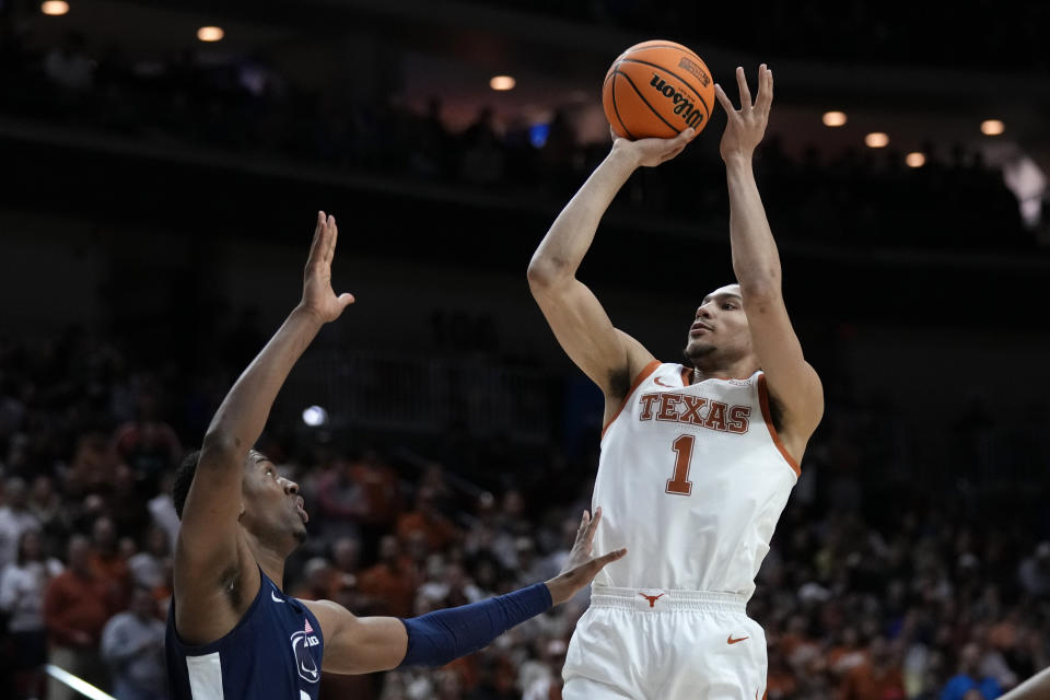 Texas forward Dylan Disu (1) shoots over Penn State forward Kebba Njie, left, in the first half of a second-round college basketball game in the NCAA Tournament, Saturday, March 18, 2023, in Des Moines, Iowa. (AP Photo/Charlie Neibergall)