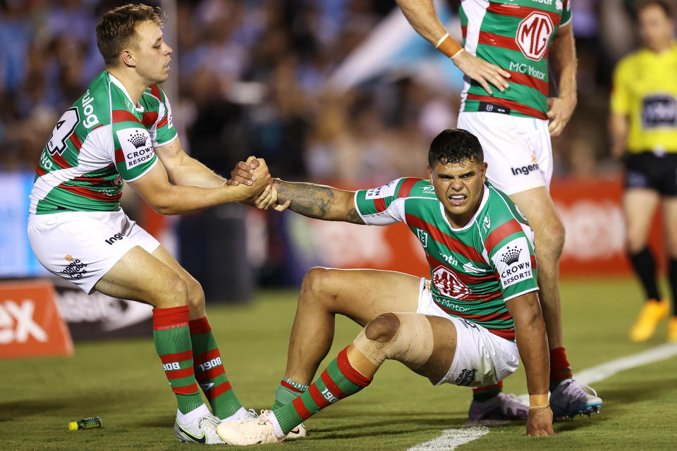 PENRITH, AUSTRALIA - MARCH 04: Blake Taaffe of the Rabbitohs helps Latrell Mitchell of the Rabbitohs to his feet during the round one NRL match between Cronulla Sharks and South Sydney Rabbitohs at BlueBet Stadium on March 04, 2023 in Cronulla, Australia. (Photo by Mark Kolbe/Getty Images)