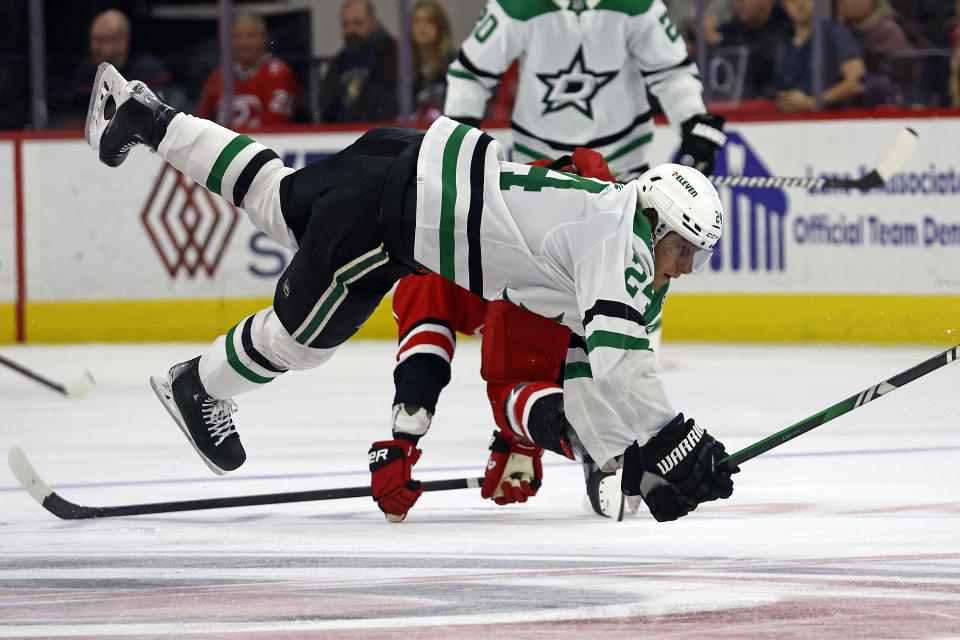 Dallas Stars' Roope Hintz (24) collides with Carolina Hurricanes' Dmitry Orlov during the third period of an NHL hockey game in Raleigh, N.C., Saturday, Feb. 24, 2024. (AP Photo/Karl B DeBlaker)