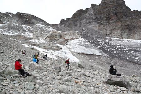 Hikers walk on a Pizol glacier, in Mels