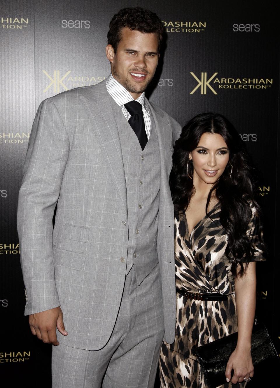 FILE - In this Aug. 17, 2011 file photo, Kim Kardashian, right, and her then fiance, NBA basketball player Kris Humphries, arrive at the Kardashian Kollection launch party in Los Angeles. A Los Angeles Superior Court Judge finalized Kardashian and Humphries divorce on Monday, June 3, 2013, roughly six weeks after the reality star and NBA player reached a settlement in their long-running divorce case. Humphries had been seeking an annulment of couple's marriage, but agreed to a divorce before a trial on the matter. He claimed the couple's lavish, televised wedding was based on fraud, but never detailed his allegations in court. (AP Photo/Matt Sayles, File)